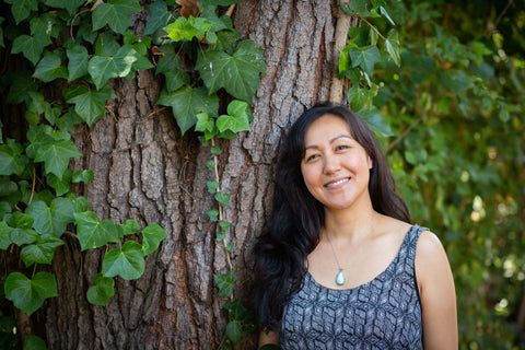 woman leaning again tree happy expansion thriving