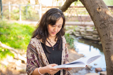 woman reading book setting intentions goals