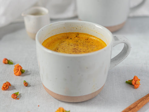 warm cup of golden milk get my golden milk honey recipe warming herbs warmth for fall season