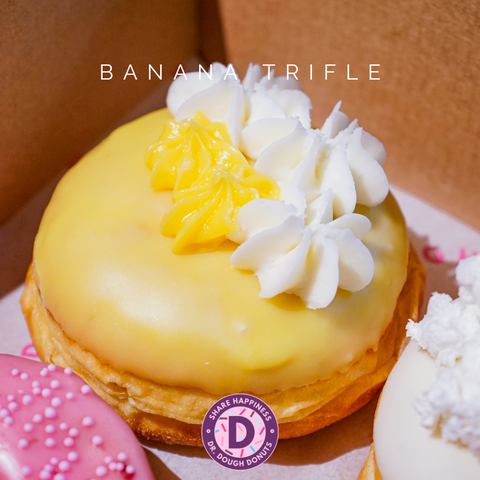 Our Banana Trifle Donut that is part of the Backyard Favourite Flavours box and is filled with vanilla custard topped with banana glaze and cream.