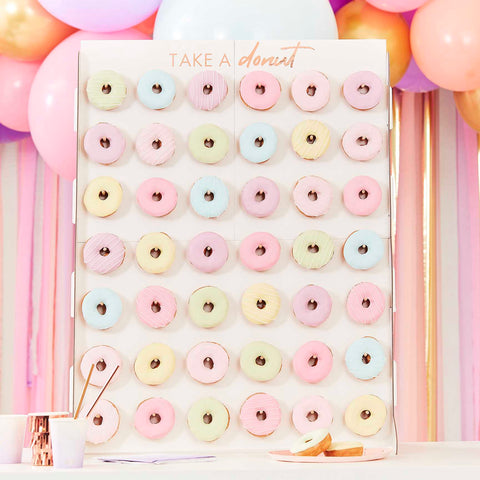 The Show Stopper donut wall holds 42 donuts. The white backing and "Take A Donut" wording in rose gold foil, makes a great canvas for your choice of donuts and can be styled around your theme. 