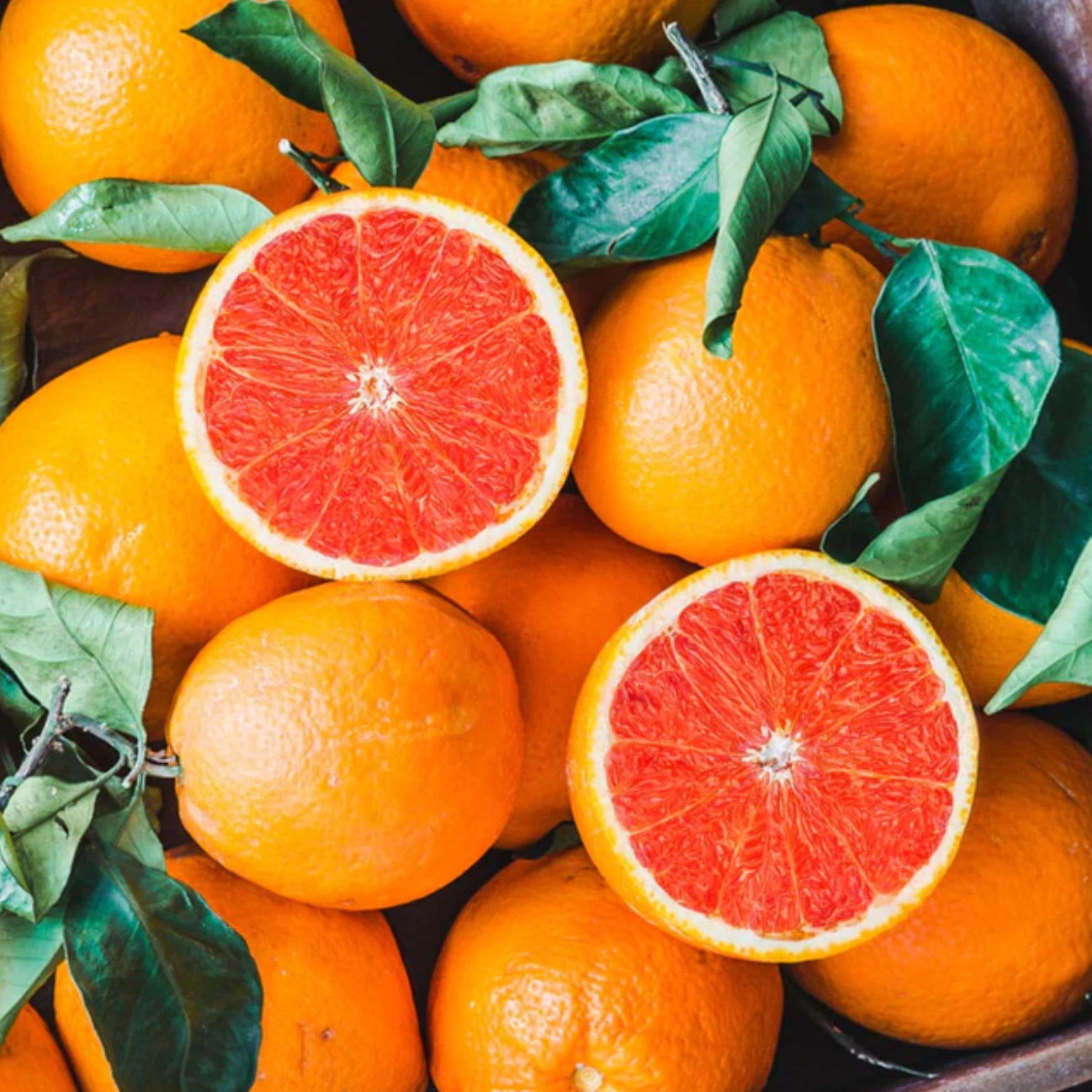 The photo shows a round piece, a pomelo slice. The inside of the exotic  fruit is pink in color, on the outside there is a yellow-green peel. Citrus  si Stock Photo 