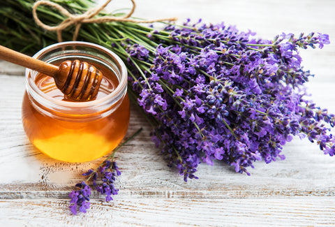 Lavender and honey jar on a rustic wooden surface