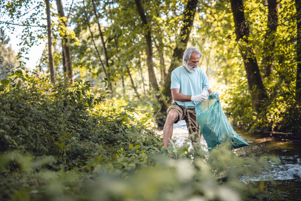 Person participating in a local sustainability project by a creek