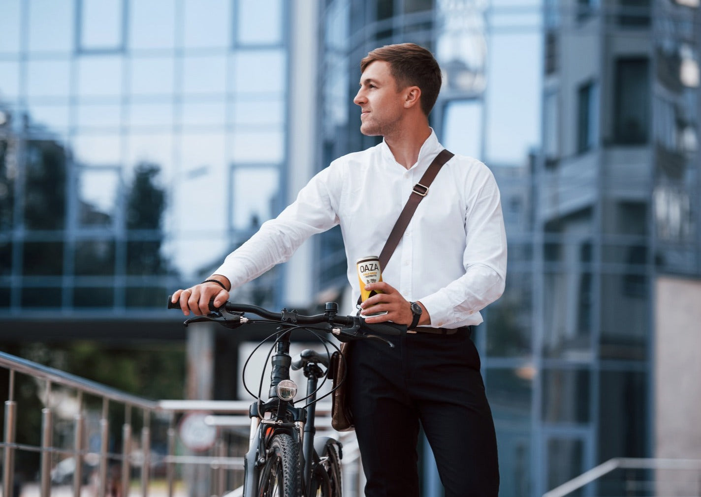 Man commuting to work, drinking Oaza Cold Brew Oat Milk.