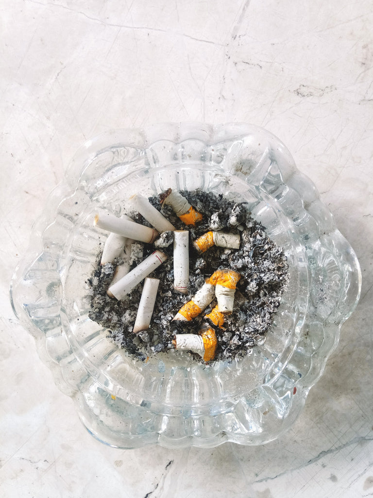 Cigarettes put out in glass ashtray