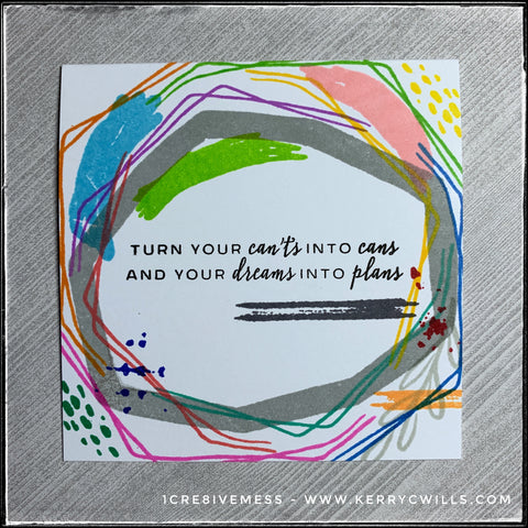 This square card is full of overlapping lines in a rainbow of colors, all surrounding the sentiment, "Turn your can'ts into cans and your dreams into plans" which is stamped in bold, black ink in the center of the card front. 