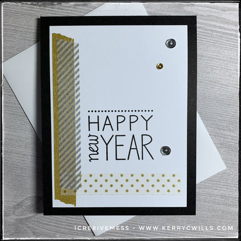 This handmade card designed to celebrate the new year has a clean and simple design utilizing gold and silver patterned washi tape alongside the stamped sentiment "Happy New Year" and a smattering of gold and silver sequins. 