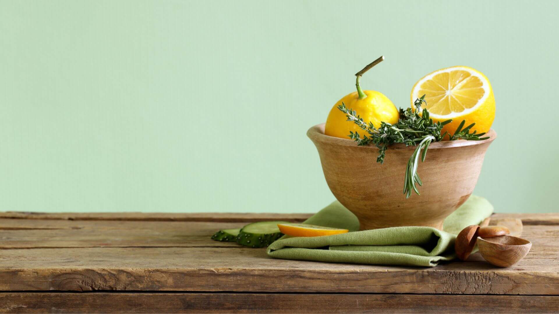 Collombatti Naturals beeswax wood polish used on a wooden bench top with a bowl of fruit on the right