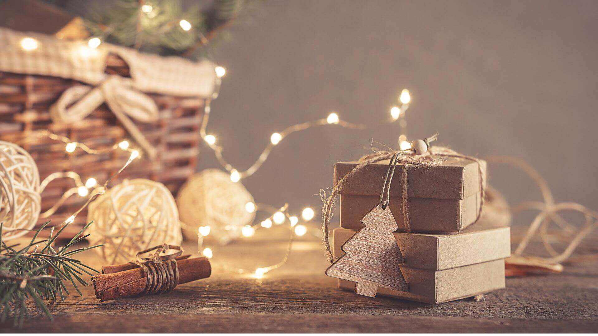 Collombatti Naturals 5 ways to reduce waste over christmas picture of gift boxes with fairy lights behind
