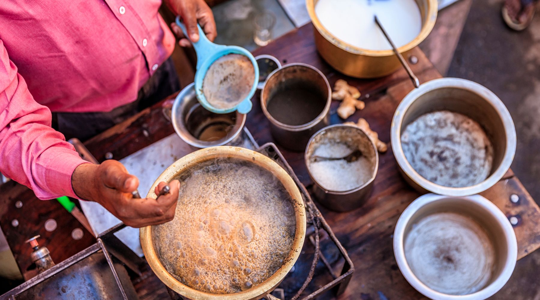 Collombatti Naturals 8 reasons to love chai this winter blog - Male in a bright pink shirt making traditional chai