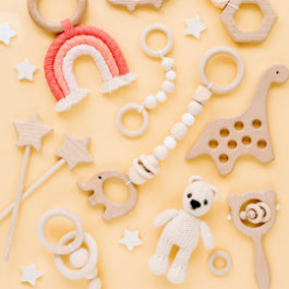Collombatti Naturals Sustainable Gifts Guide to Help You Shop with a Conscience Blog - an array of wooden toys on a yellow background