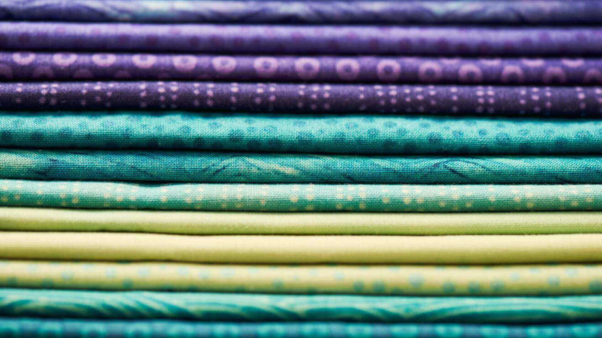 Collombatti Naturals Beeswax Wraps FAQ picture of a stack of colourful quilting fabrics