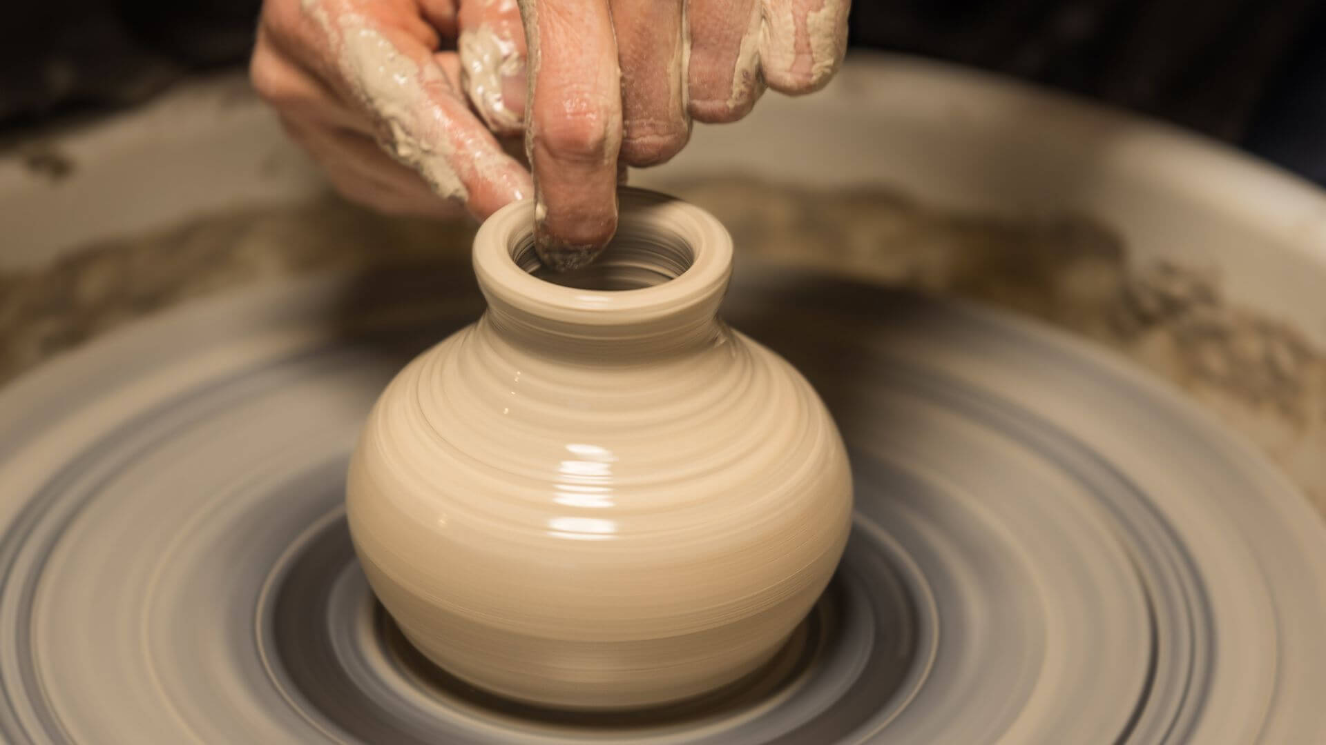 Collombatti Naturals Embracing sustainability picture of someone making a clay pot on a pottery wheel