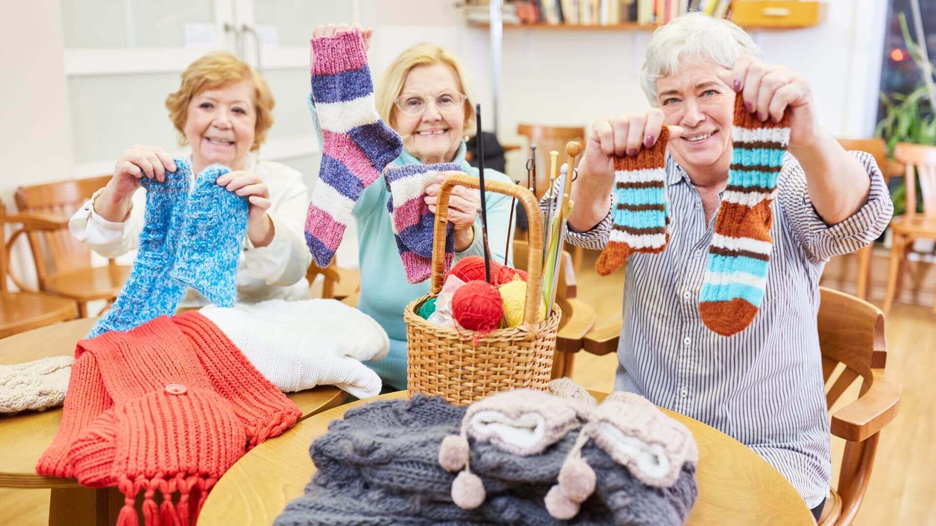 Collombatti naturals handmade and sustainable christmas gifts picture of ladies showing off their knitted garments and socks