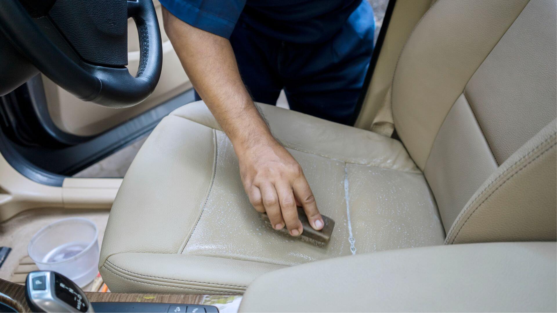 Collombatti Naturals step by step guide to using beeswax leather polish picture of someone cleaning their leather car seat