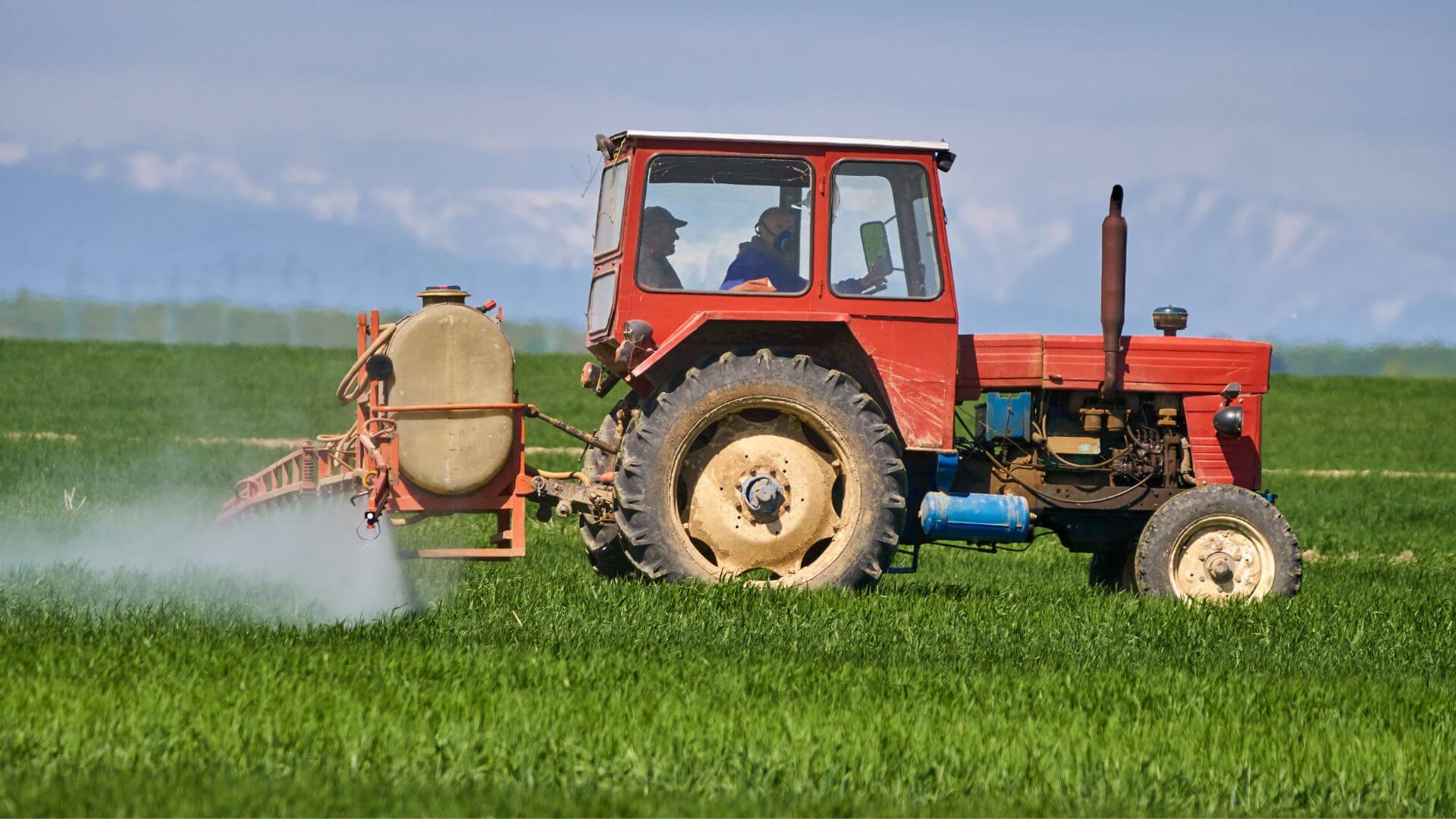 Collombatti Naturals Why Beeswax Candles are the eco-friendly choice picture of a tractor spraying crops whilst the driver wears a gas mask