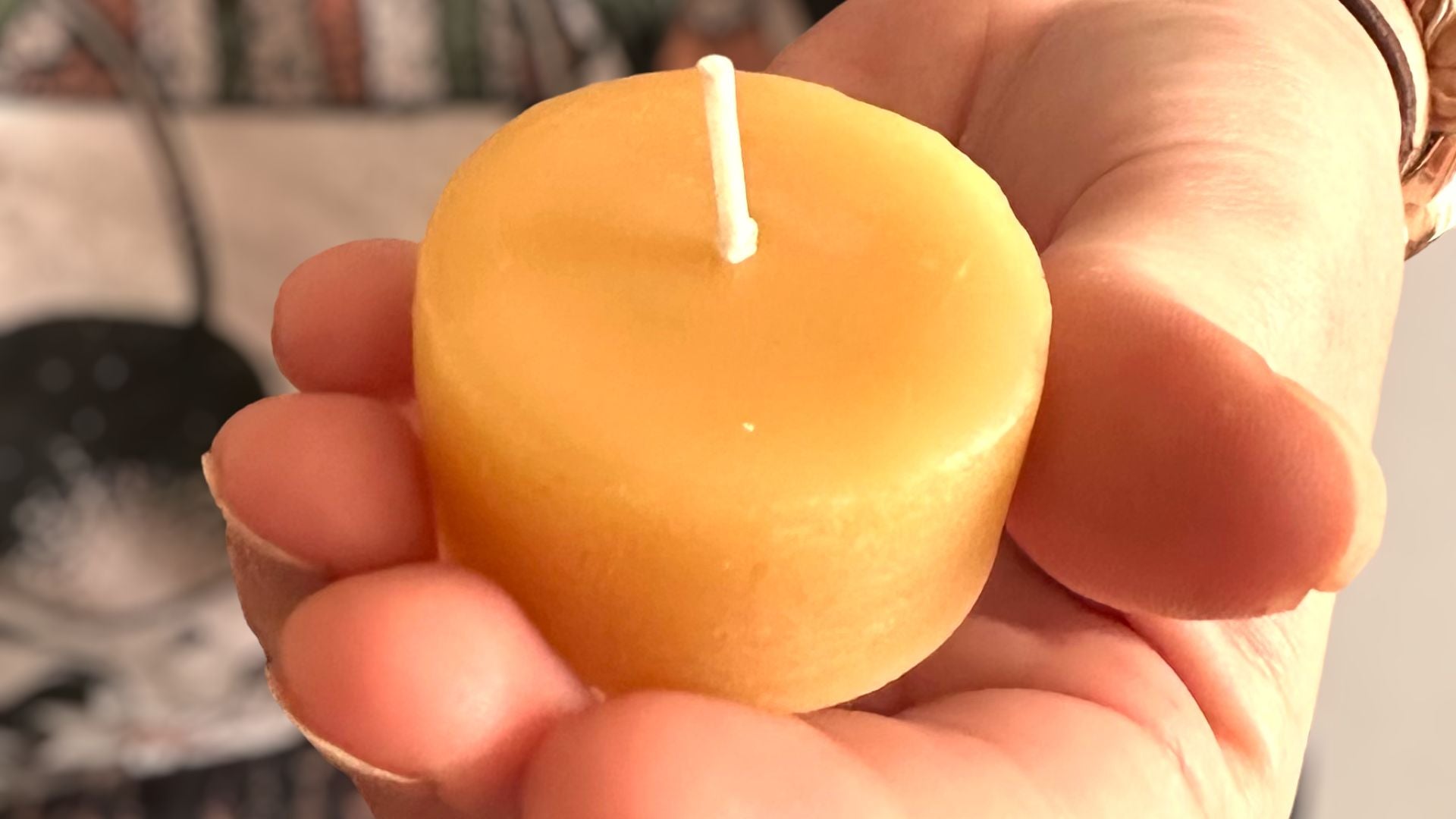 Collombatti Naturals Why beeswax candles are the eco-friendly choice picture of a womans hand holding a beeswax tea light