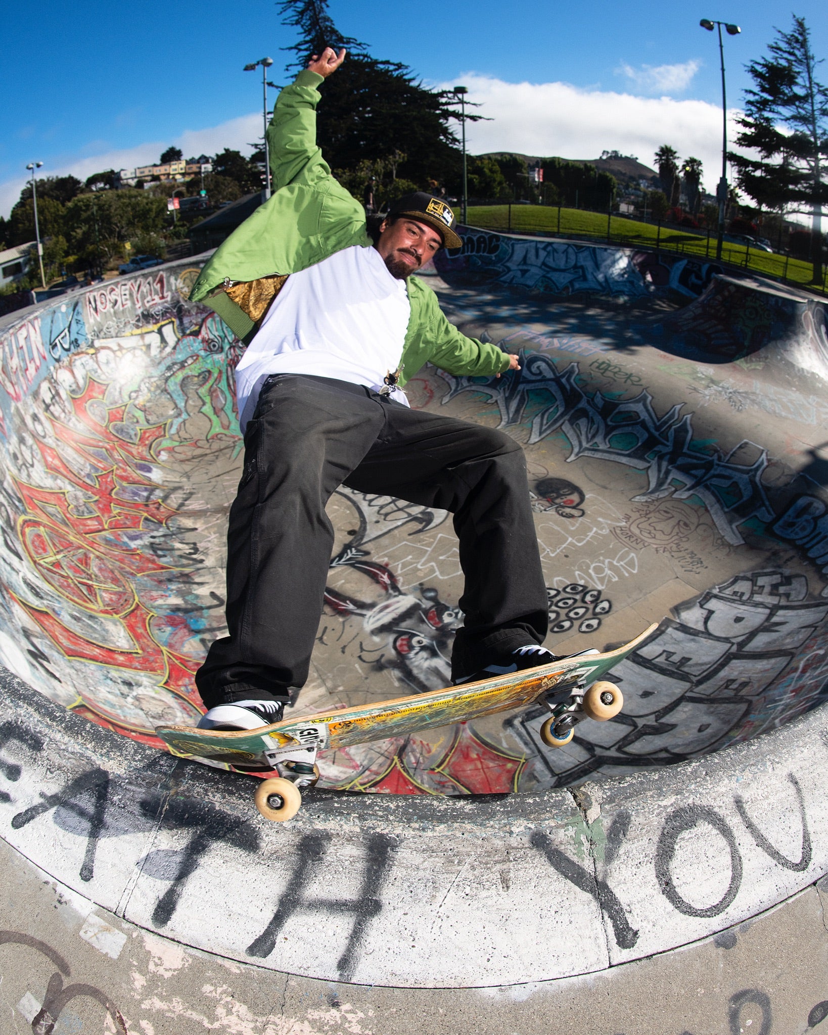 guy skating wearing a moss green derby jacket 