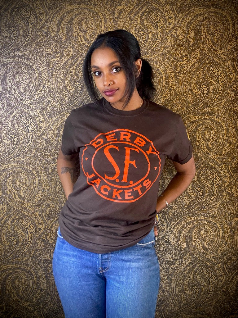 Meron wearing a Brown shirt with sf derby token T- shirt with Orange design