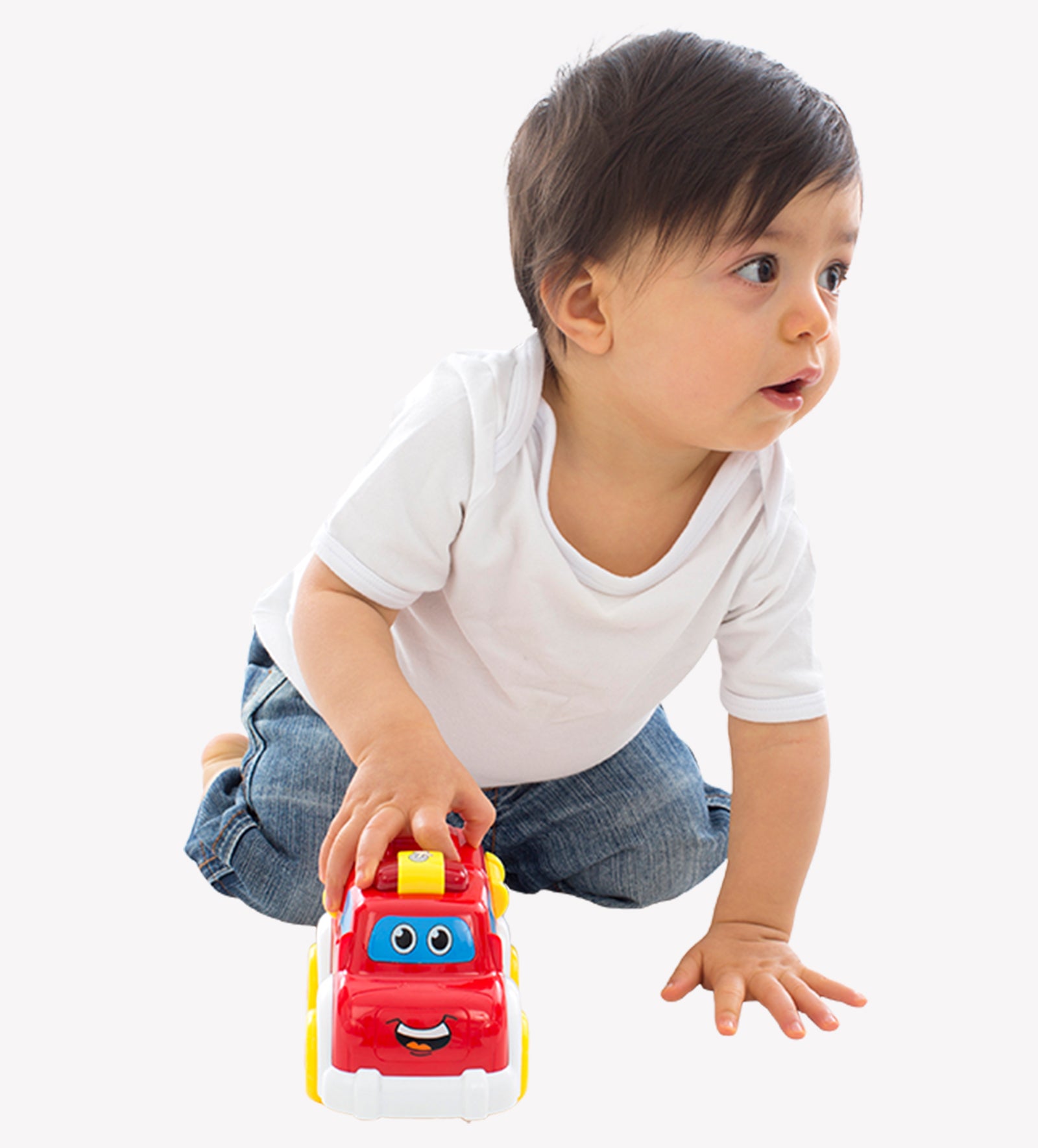 A boy is playing and pushing Playgro Firetruck toys on the floor