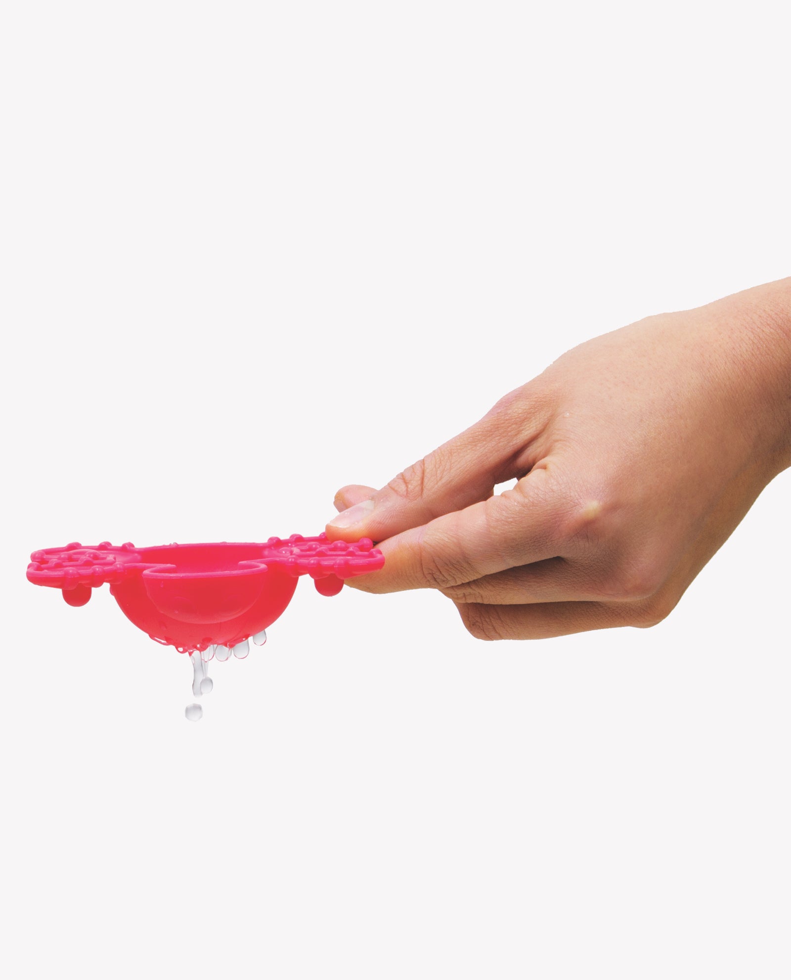 A hand holding red Playgro Scoop and Splash toy with water