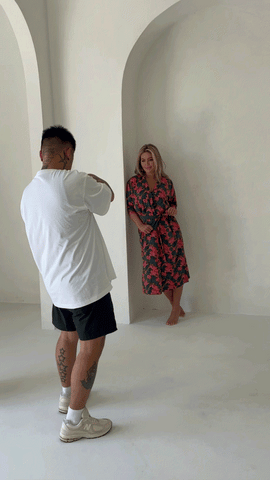 Video of photographer taking photo of model wearing floral print robe