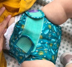 Baby on change mat in cloth nappy