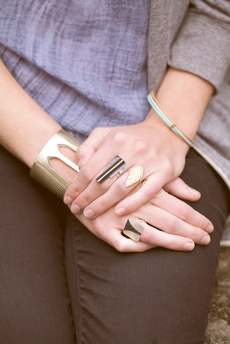 Close up of the bridge collection jewelry on hands in the lap.