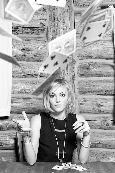 Model throws her playing cards at the camera.