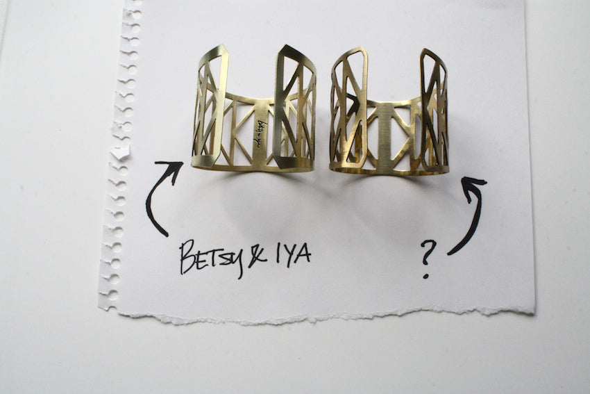 An image showing the interior of the betsy & iya Fremont Bridge cuff bracelet with the other being what we think is a copy of the design.