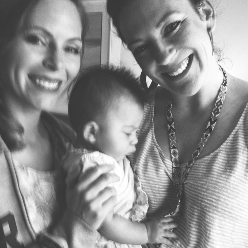 Betsy, Iya, and baby Charlotte admiring my necklace.