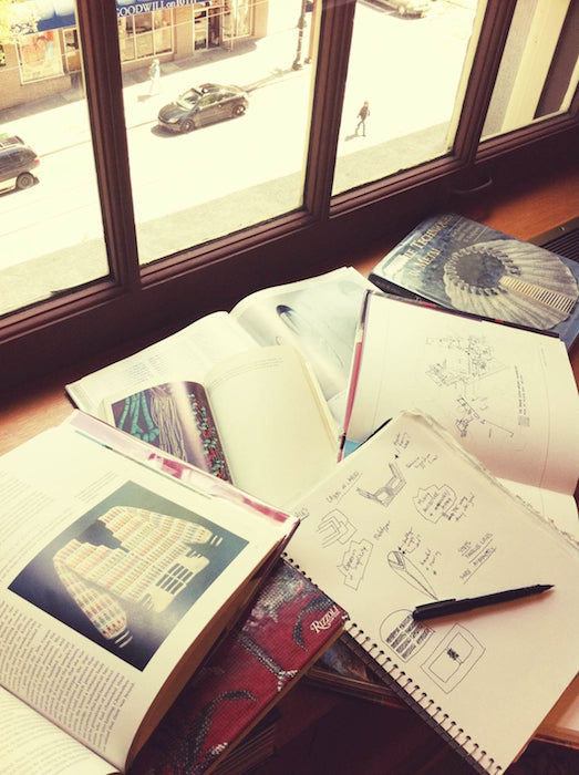 Library books laid out on a sunny windowsill. 