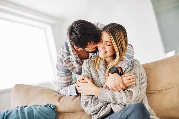 a man and woman sitting on a couch