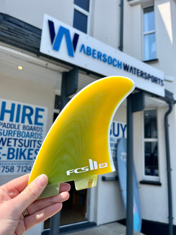 holding a surf FCS fin outside Abersoch Watersports 