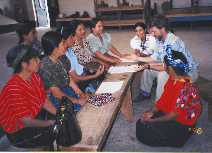 Image: A group of Guatemalan women sitting at a bench, having a conversation with Dean.