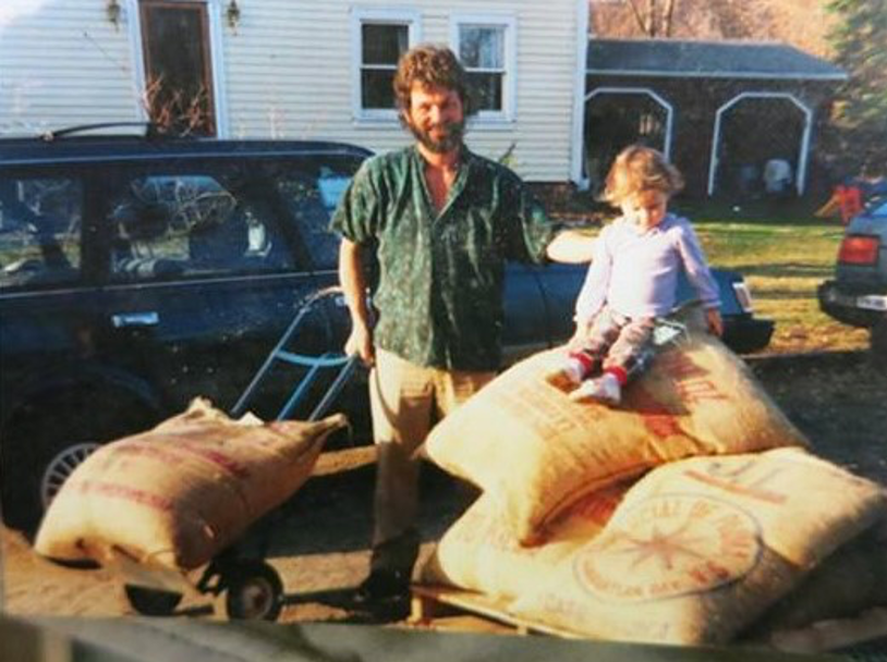 Dean with daughter sitting on coffee bags