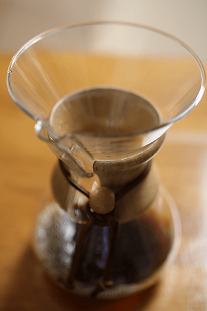 A Chemex coffee maker filled with coffee