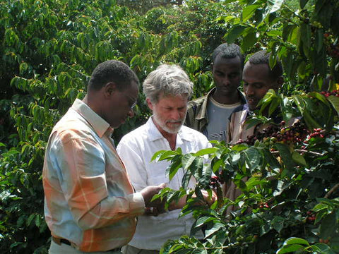 Dean and a farmer in Ethiopian drylands coffee bush 