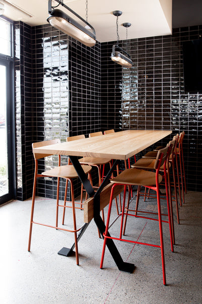 Restaurant community table by Edgework Creative