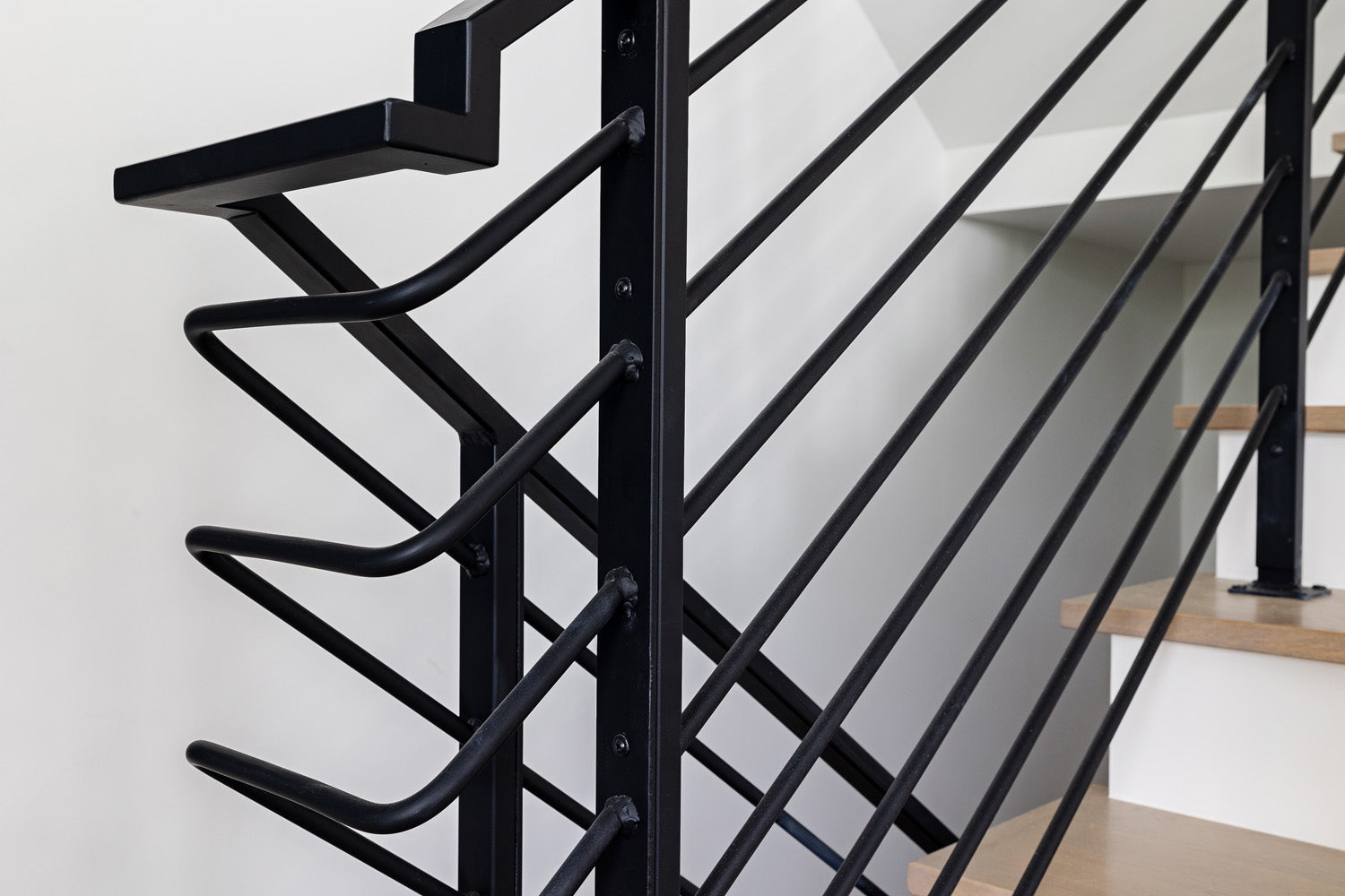Modern metal stair railing by Edgework Creative