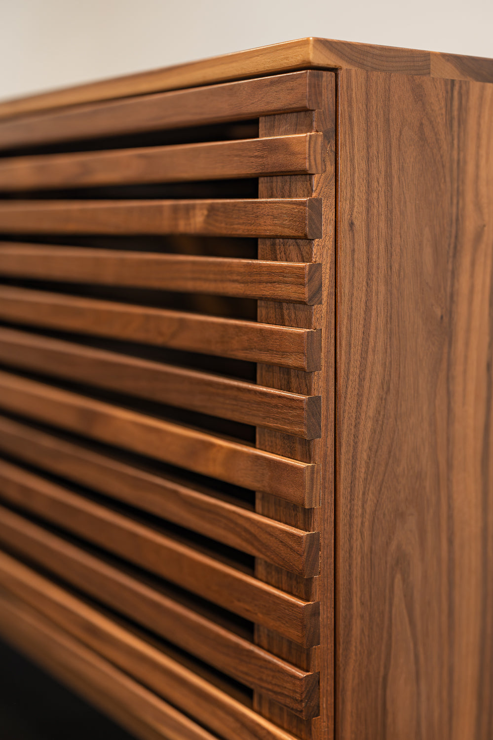 Slatted walnut console table by Edgework Creative