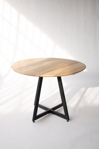 Wood and metal dining table by Edgework Creative