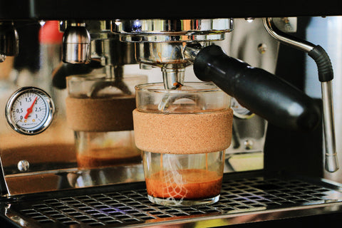 reusable coffee cup on an espresso machine