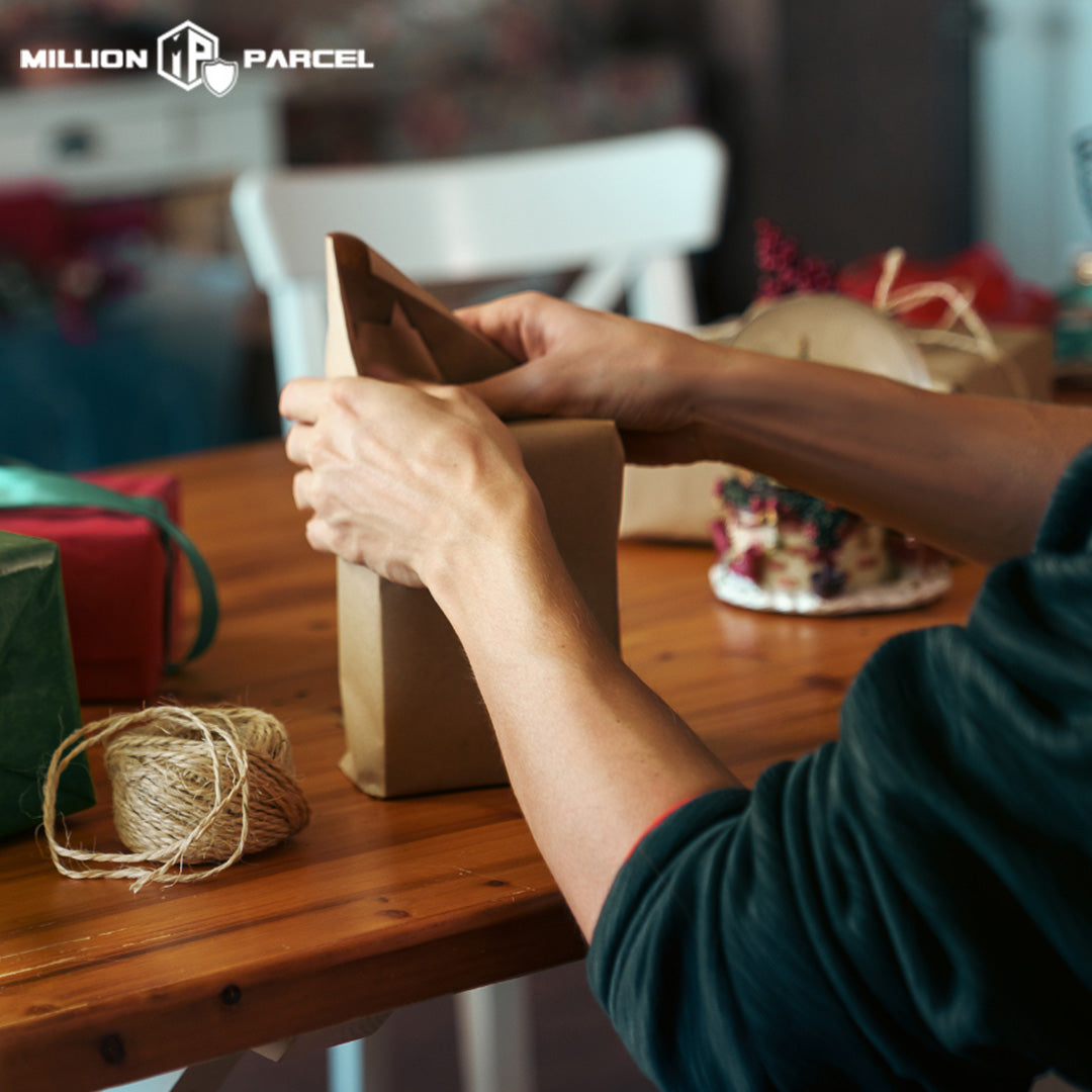 Man wrapping a Christmas gift with craft paper