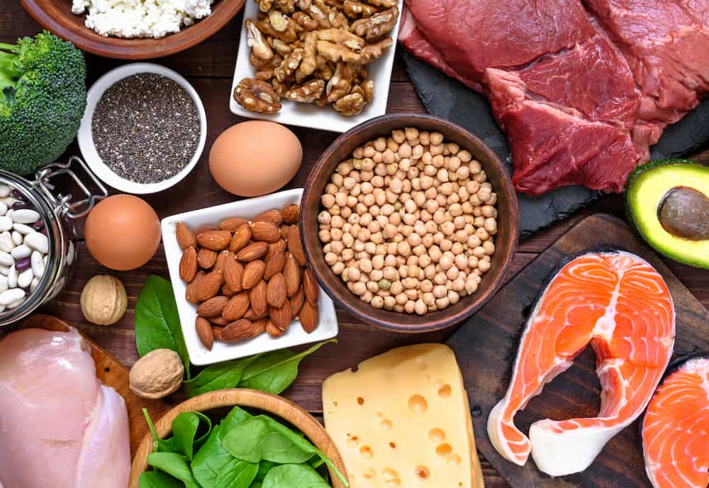 A range of healthy foods like eggs, lean protein, seeds and nuts showing how to get amino acid nootropics via diet.