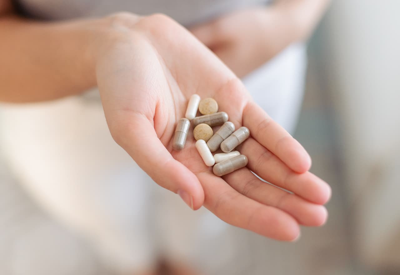 An open handing hold a CVS Nootropics and Brain Supplements Selection as capsules and pills.