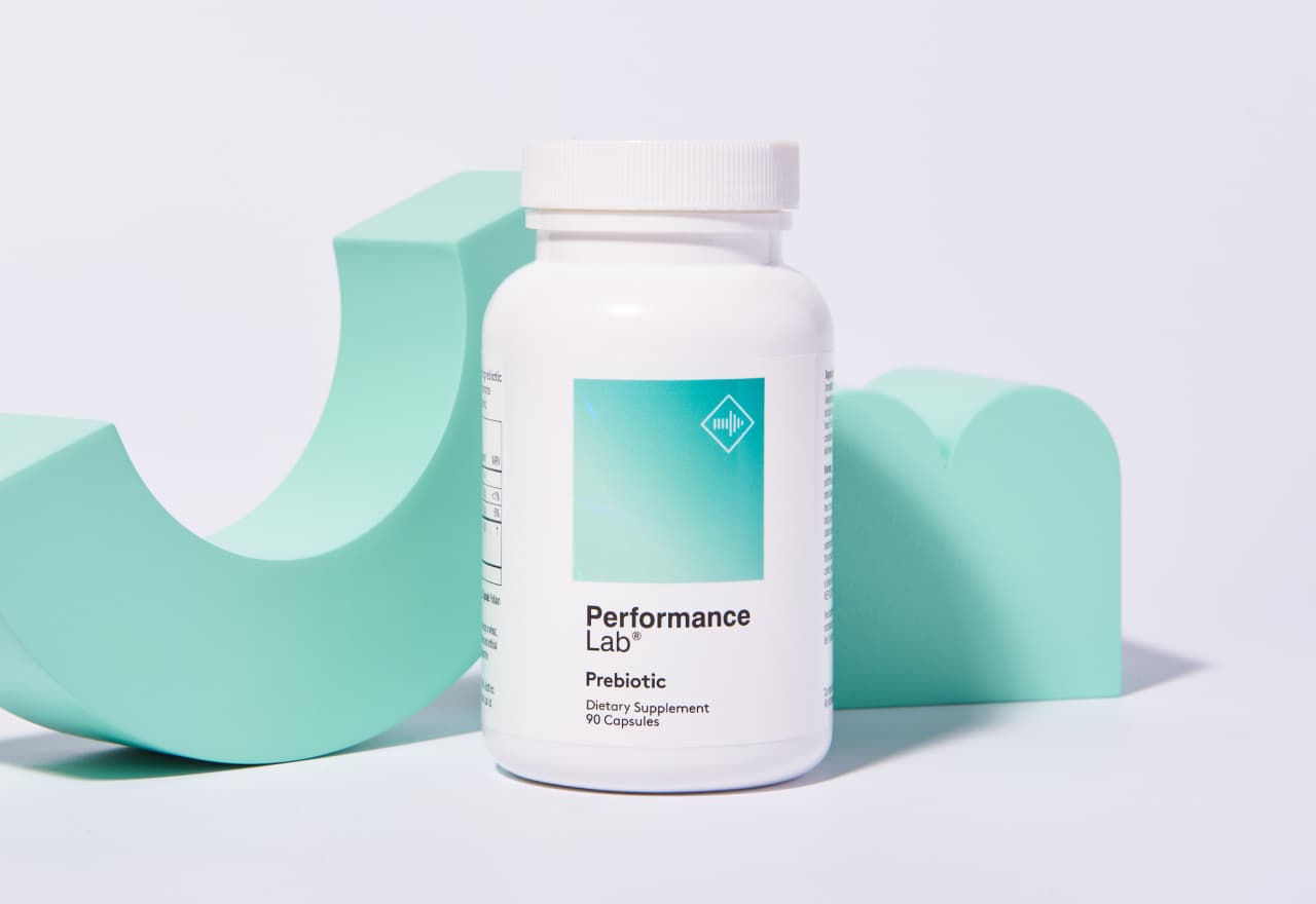 Performance Lab® Prebiotic bottle next to mint green geometrical shapes.