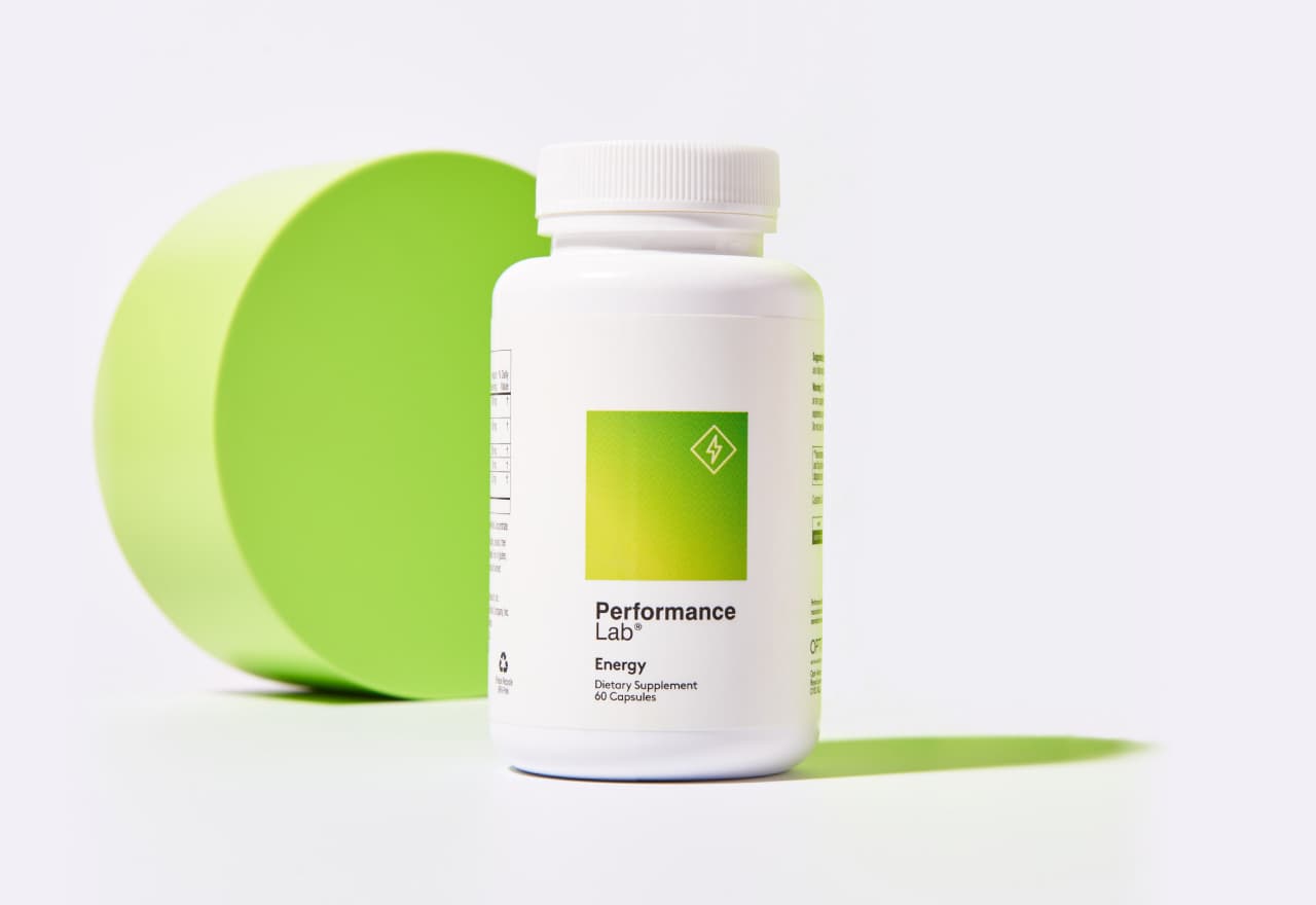 Performance Lab® Energy bottle next to a light green geometrical shape.