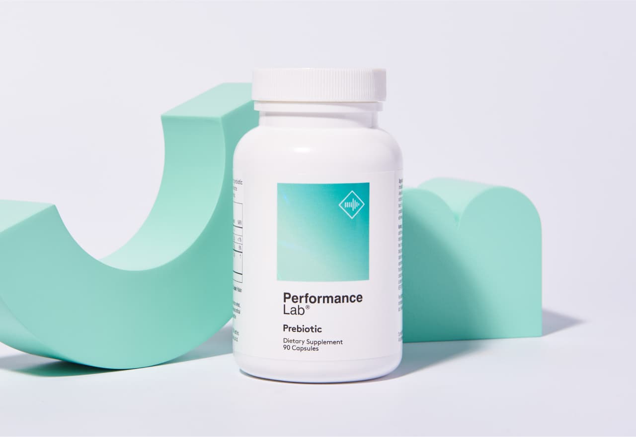 Performance Lab® Prebiotic shown next to some mint green three dimensional abstract geometric forms.